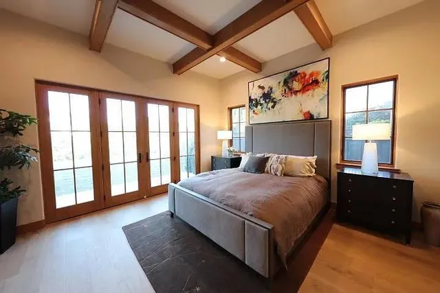 a large bedroom with a large bed and a large window