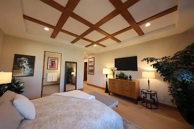 a bedroom with furniture and a flat screen tv