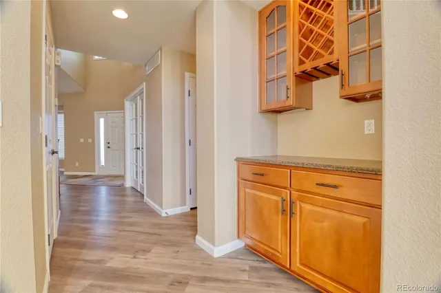 a view of a hallway with wooden floor and closet