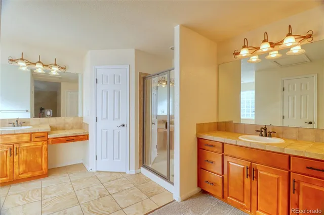 a bathroom with a granite countertop sink a large mirror and a bathtub