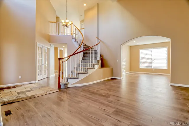 a view of a livingroom with wooden floor and stairs