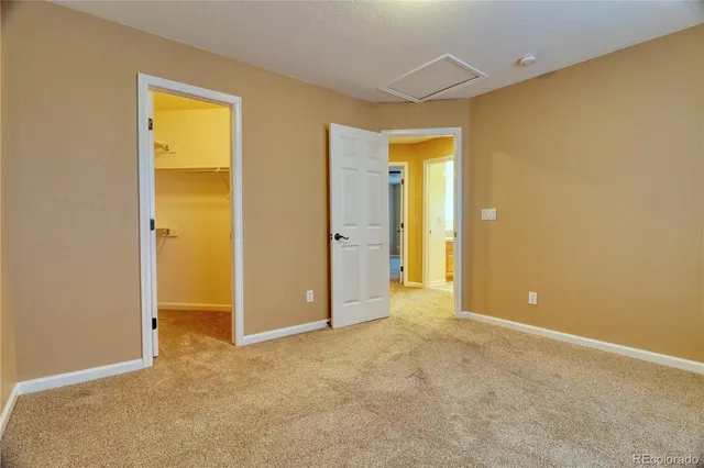 an empty room with a bathroom and a sink