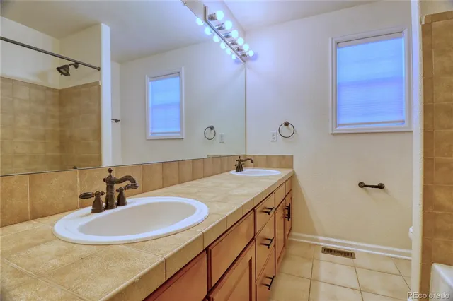 a bathroom with a sink a vanity and a mirror