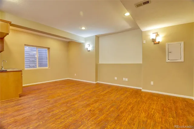 a view of a kitchen with granite countertop cabinets and wooden floor