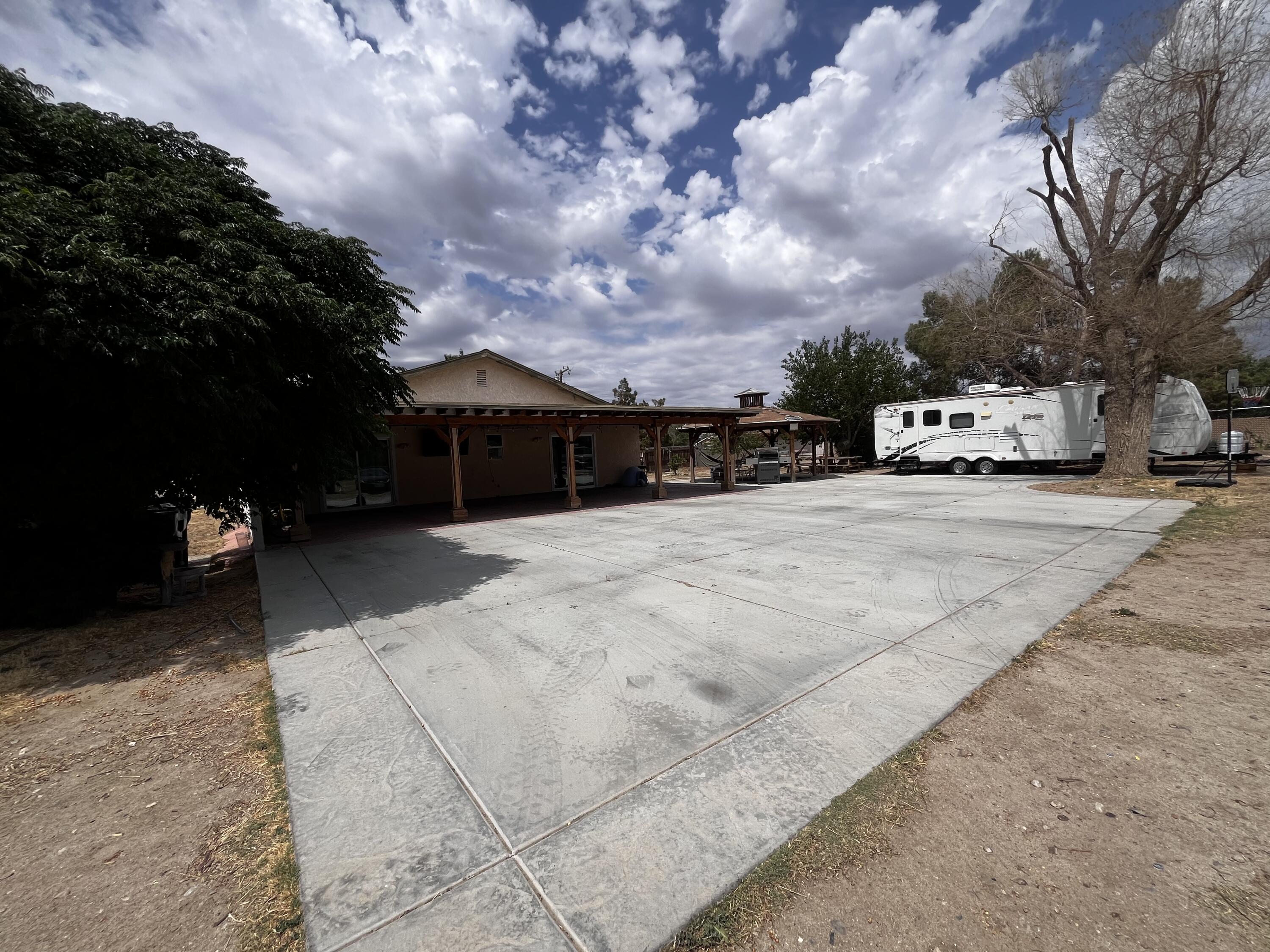 10306 East Ave R 10 Littlerock, CA 93543 - Photo 4 of 7 a view of couple of cars parked in front of house
