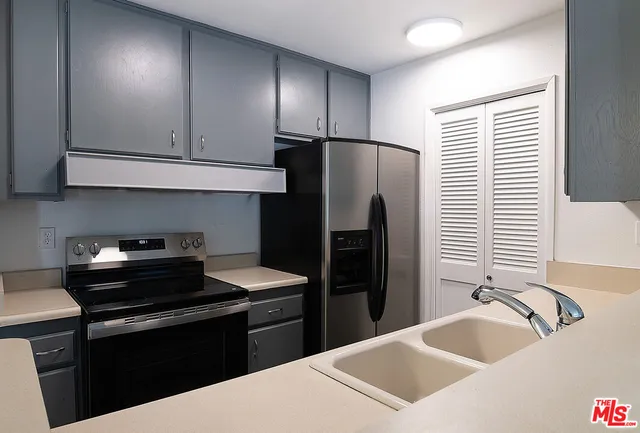 a kitchen with a refrigerator sink and stove