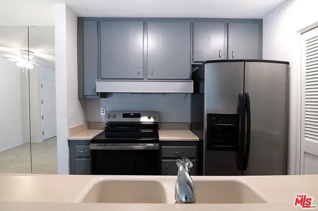 a kitchen with a refrigerator and a stove