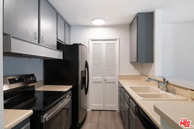 a kitchen with a sink stove and refrigerator