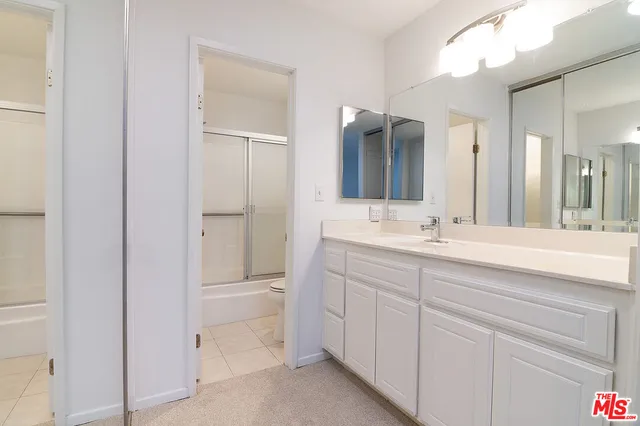 a bathroom with a double vanity sink mirror and double