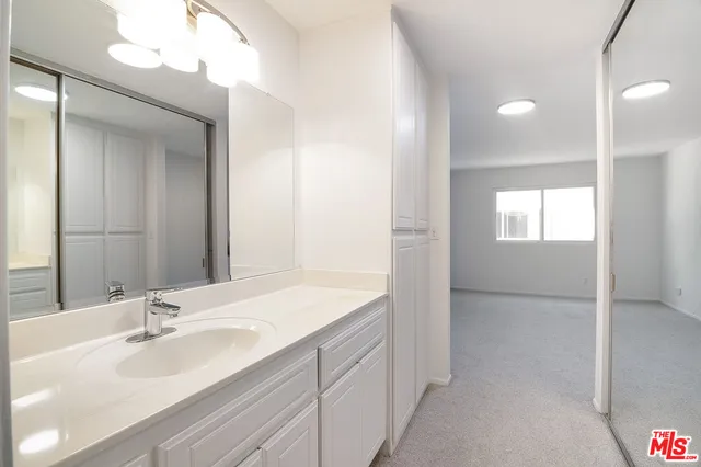 a bathroom with a sink a vanity and a mirror