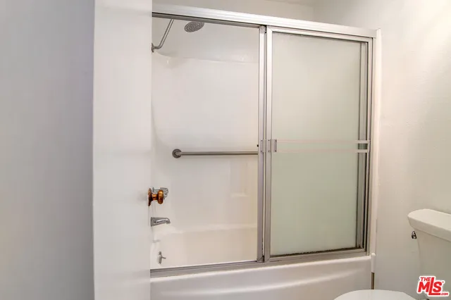 a bathroom with a shower and a bath tub