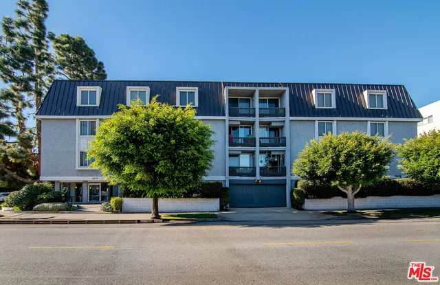 a front view of a building and a garden