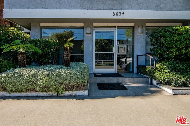 a view of a house with potted plants