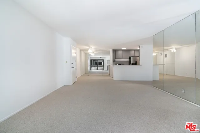 a view of a kitchen with a sink and a refrigerator