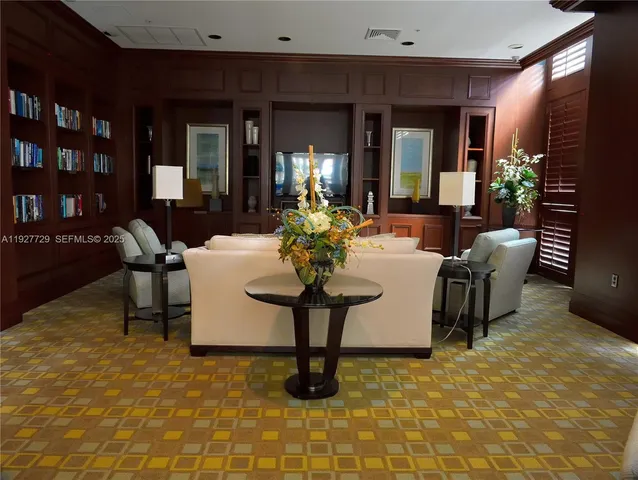 a living room with furniture a lamp and a window
