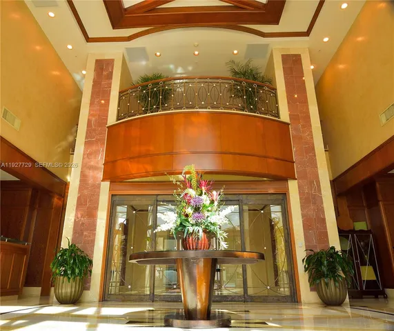 a backyard of a house with stainless steel appliances wooden floor and seating space