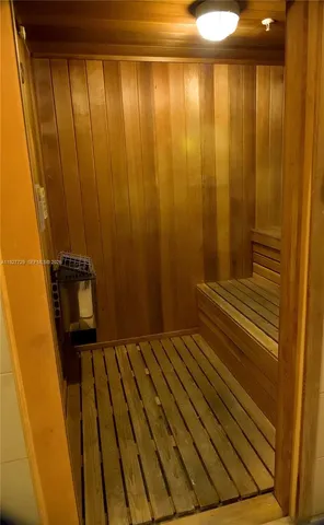 a living room with fireplace furniture and a large window