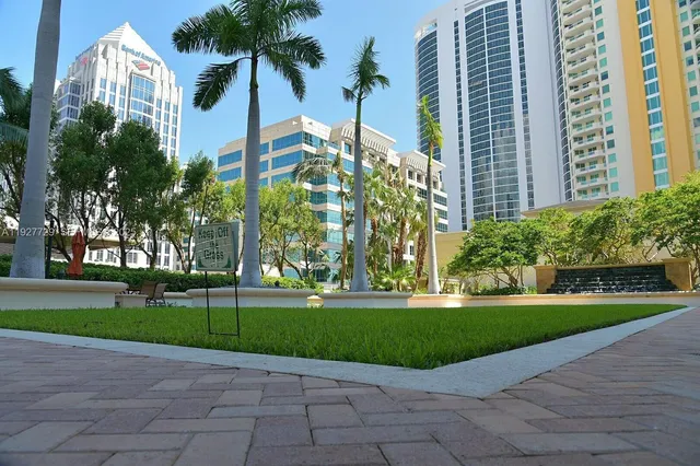 a backyard of a house with stainless steel appliances wooden floor and seating space