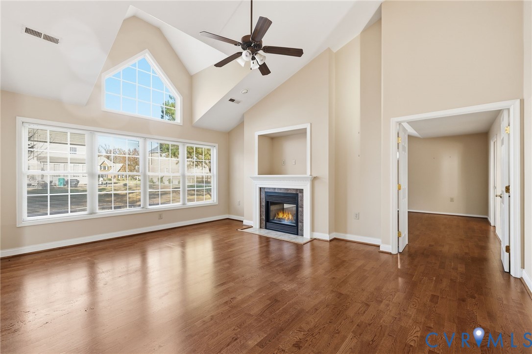 102 Creek Point Court Colonial Heights, VA 23834 - Photo 12 of 45 a view of an empty room with wooden floor fireplace and a window
