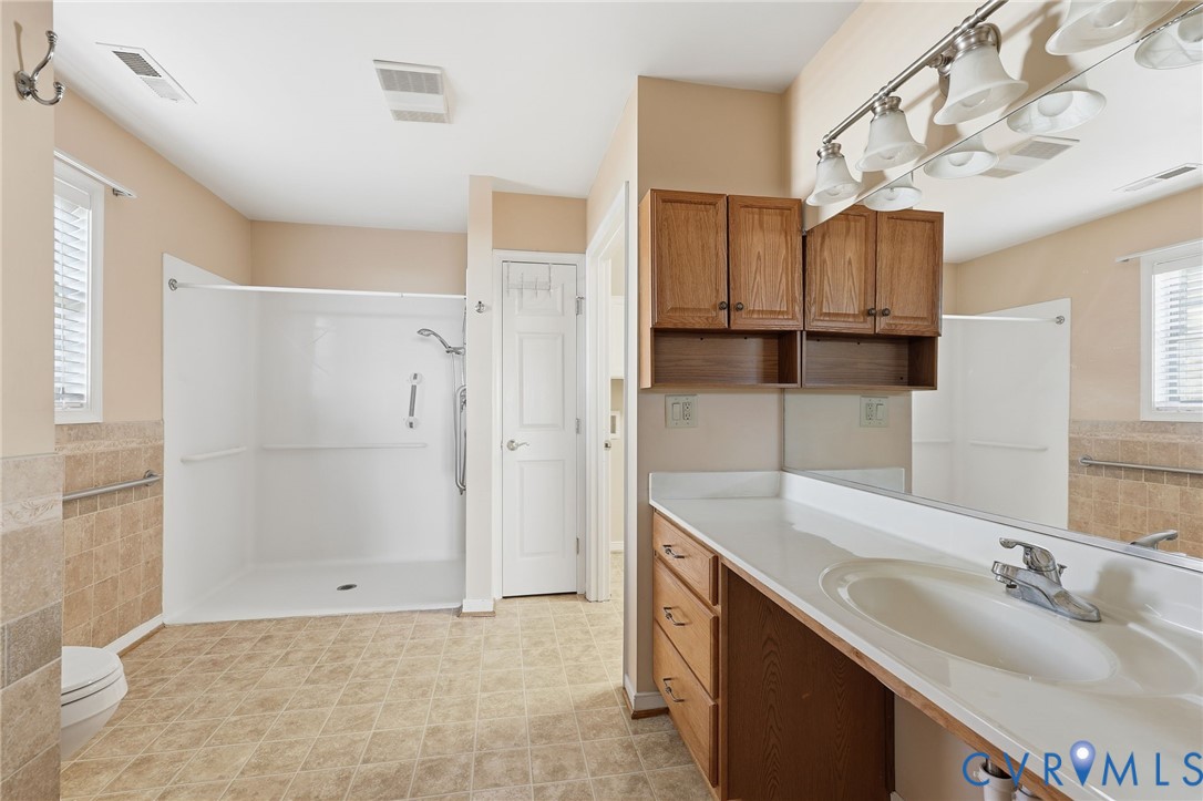 102 Creek Point Court Colonial Heights, VA 23834 - Photo 27 of 45 a bathroom with a sink vanity granite tub shower and a mirror