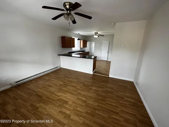a view of a kitchen with a sink and a refrigerator