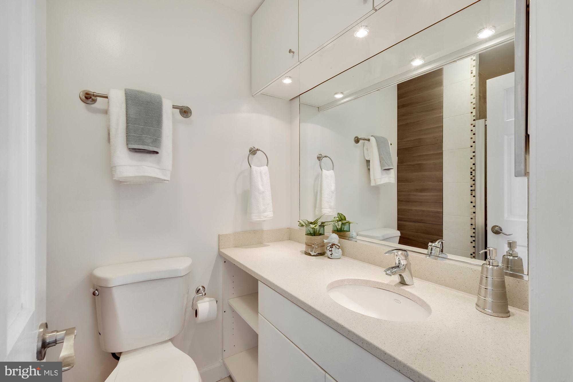 955 26th Street Northwest, Unit 707 Washington, DC 20037 - Photo 11 of 20 a bathroom with a sink a toilet and shower