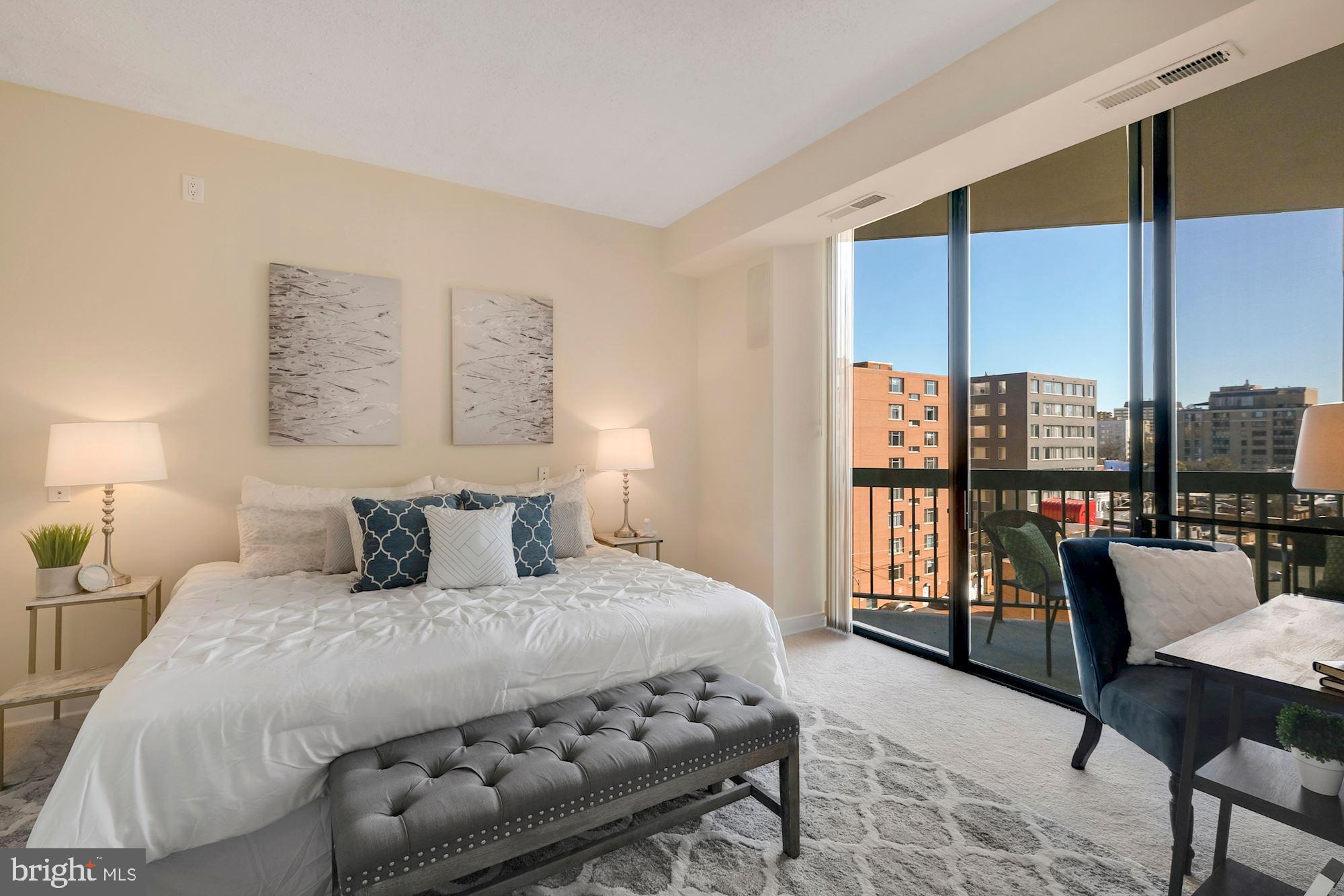 955 26th Street Northwest, Unit 707 Washington, DC 20037 - Photo 12 of 20 a bedroom with a bed a large window and walk in closet