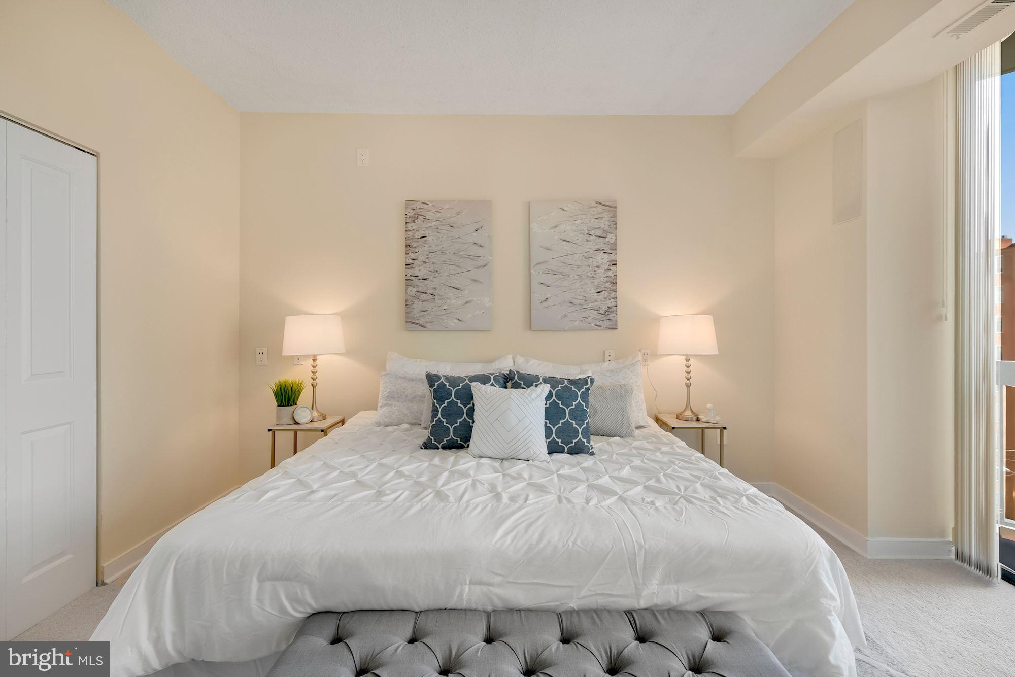 955 26th Street Northwest, Unit 707 Washington, DC 20037 - Photo 13 of 20 a bedroom with a bed and a night stand
