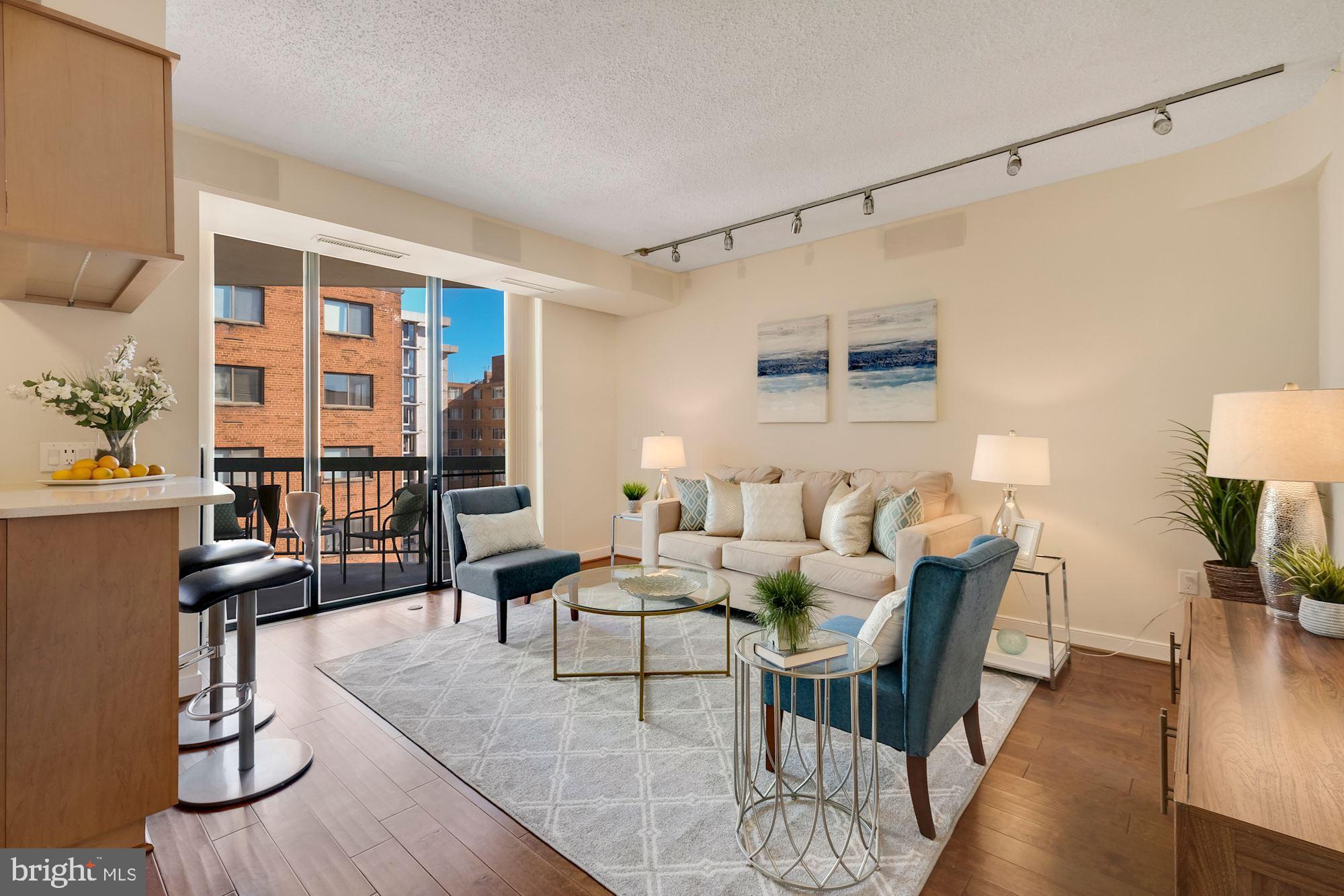 955 26th Street Northwest, Unit 707 Washington, DC 20037 - Photo 6 of 20 a dining room with furniture a chandelier and wooden floor