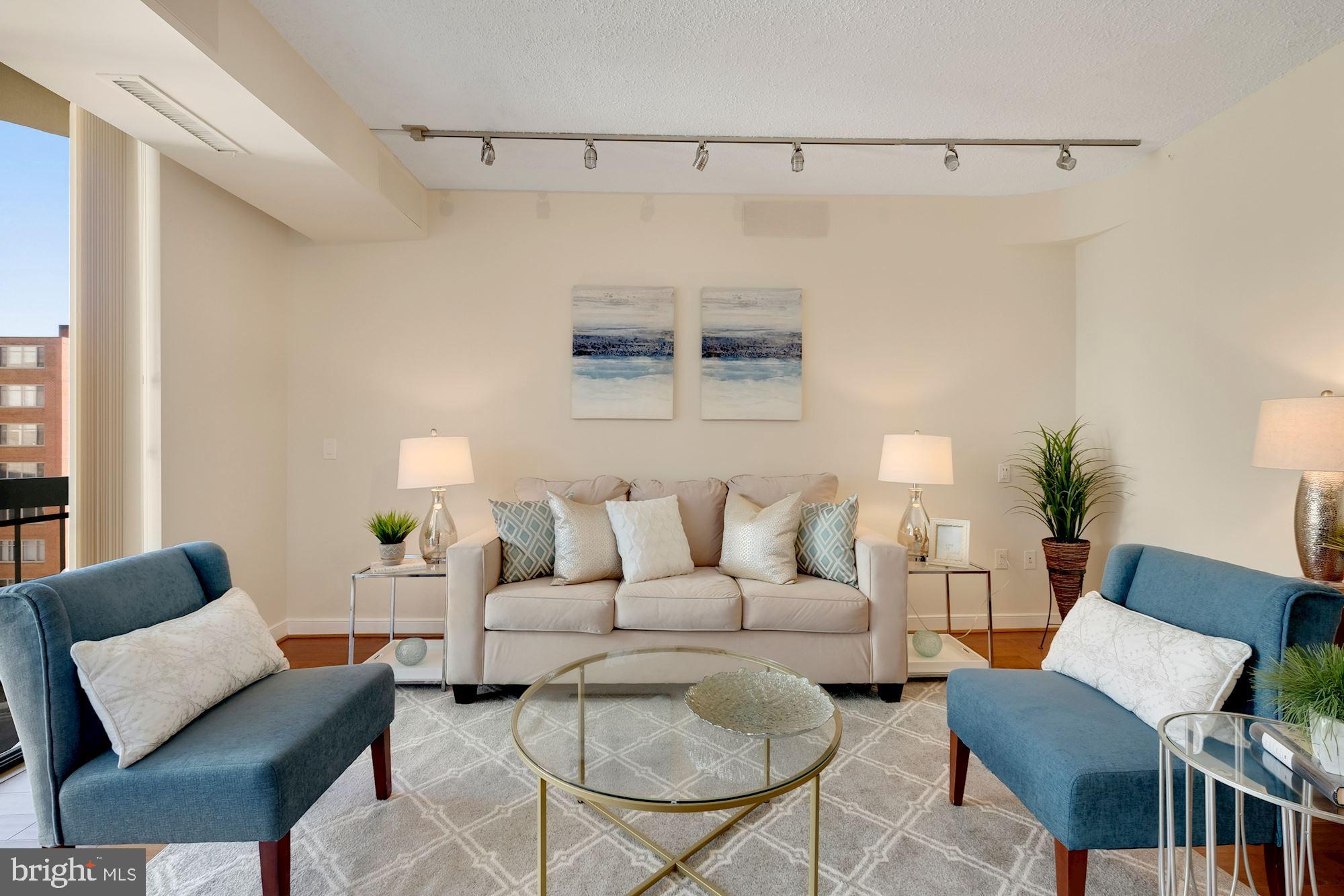 955 26th Street Northwest, Unit 707 Washington, DC 20037 - Photo 7 of 20 a living room with furniture and a window