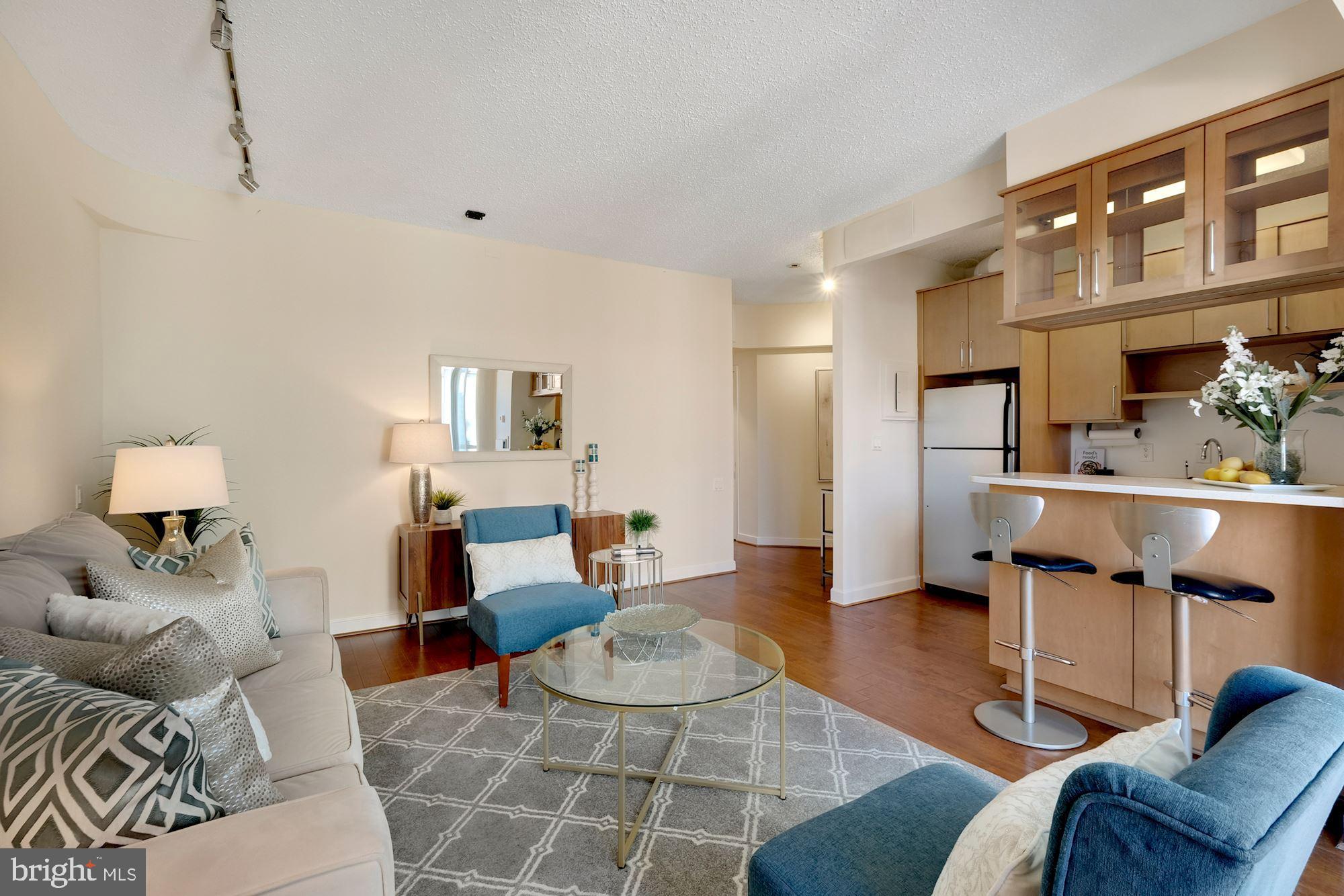 955 26th Street Northwest, Unit 707 Washington, DC 20037 - Photo 8 of 20 a living room with furniture and a wooden floor