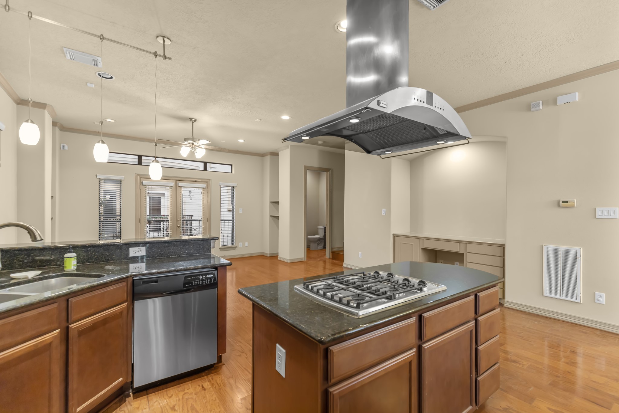 1607 Bass Street, Unit B Houston, TX 77007 - Photo 15 of 39 a kitchen with kitchen island granite countertop a sink stove and cabinets