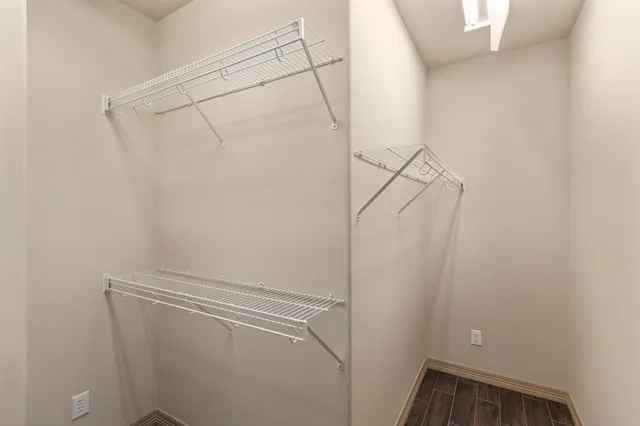 a view of storage and utility room with racks on the wall