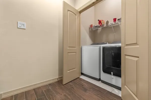 a view of storage and utility room with wooden floor