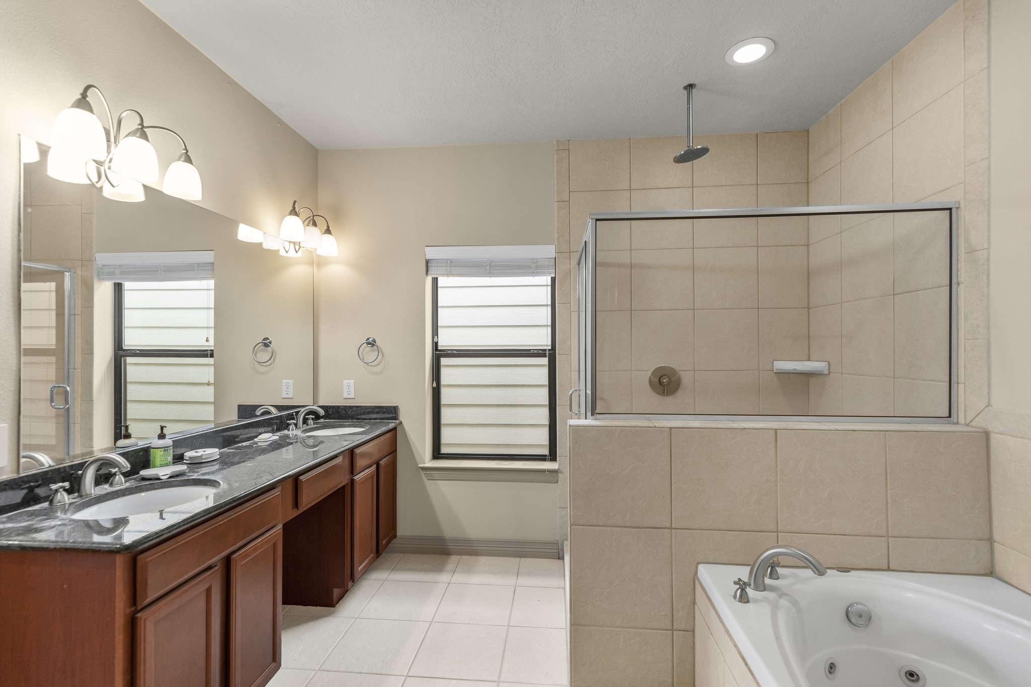 1607 Bass Street, Unit B Houston, TX 77007 - Photo 31 of 39 a bathroom with a sink vanity granite tub shower and a mirror