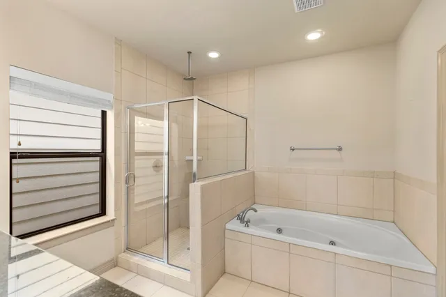 a bathroom with a shower and a tub