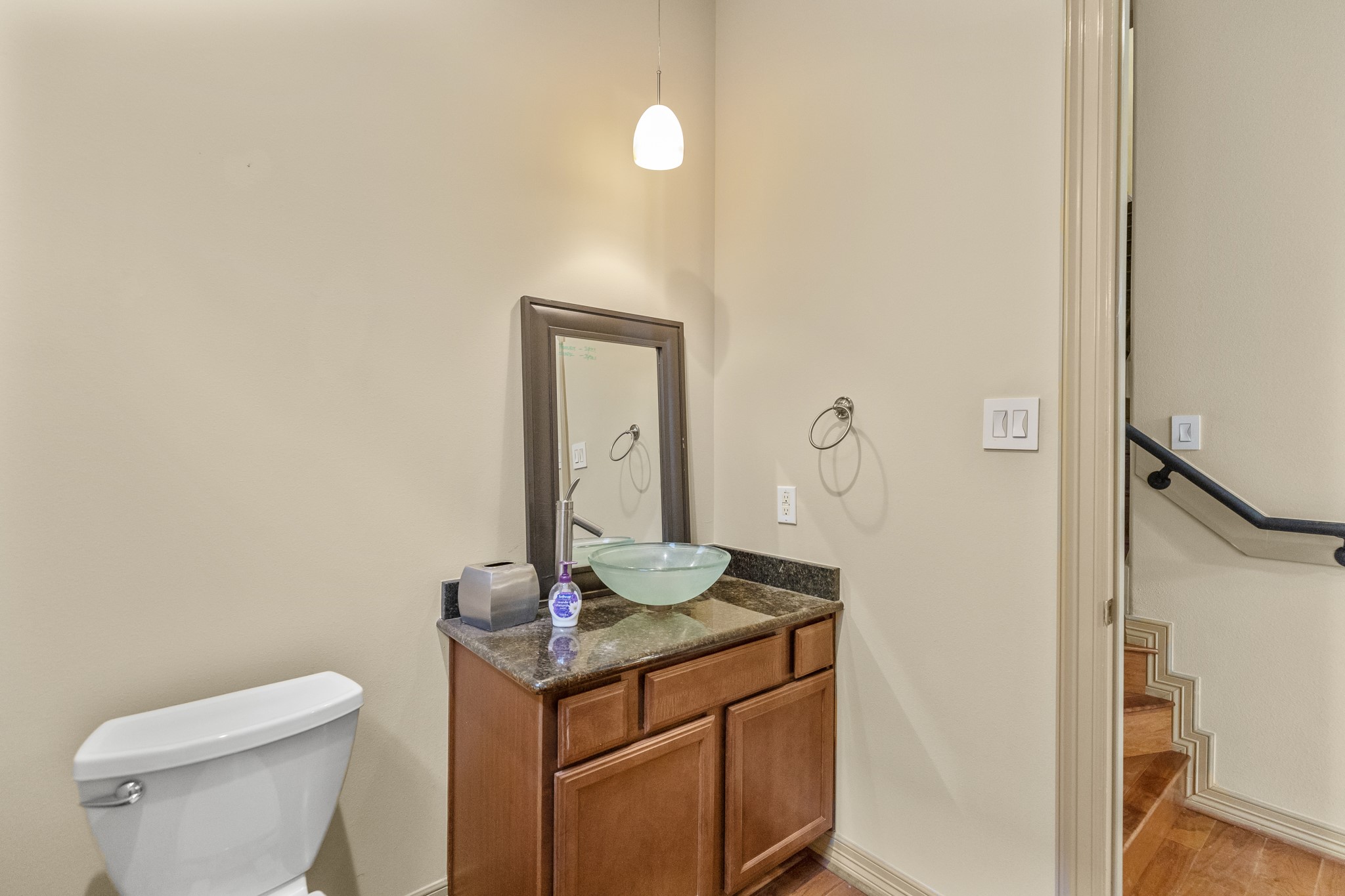 1607 Bass Street, Unit B Houston, TX 77007 - Photo 10 of 39 a bathroom with a granite countertop sink a toilet and a mirror
