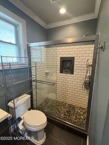 a bathroom with a toilet and a shower