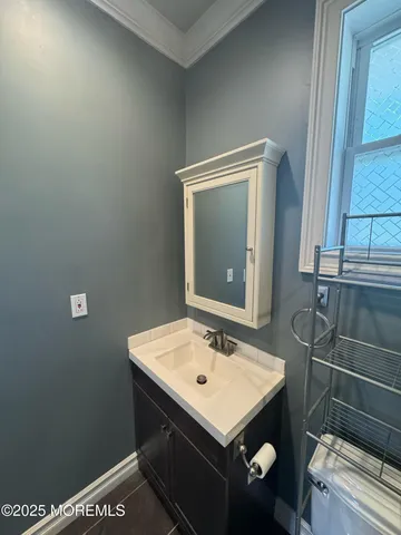a bathroom with a sink a toilet and a mirror