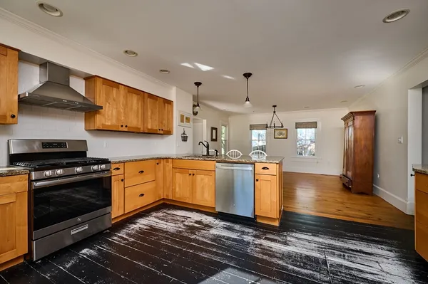 a kitchen with stainless steel appliances granite countertop a stove a sink and a refrigerator
