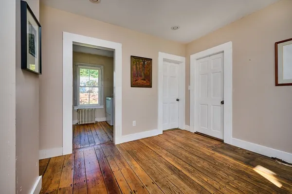 a view of a livingroom with wooden floor and closet