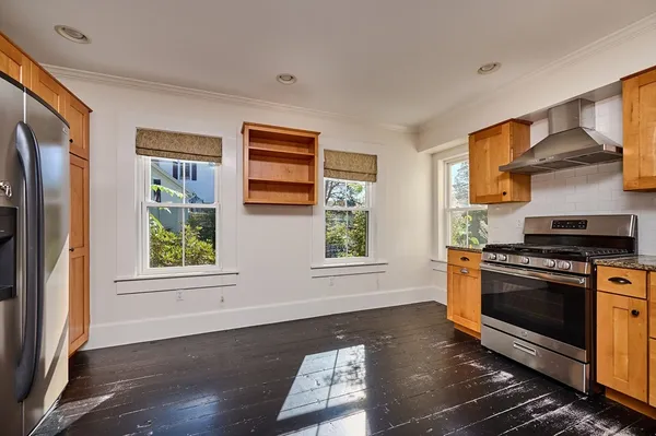a kitchen with stainless steel appliances granite countertop a stove a sink and a refrigerator