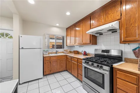 a kitchen with stainless steel appliances a stove a sink and cabinets