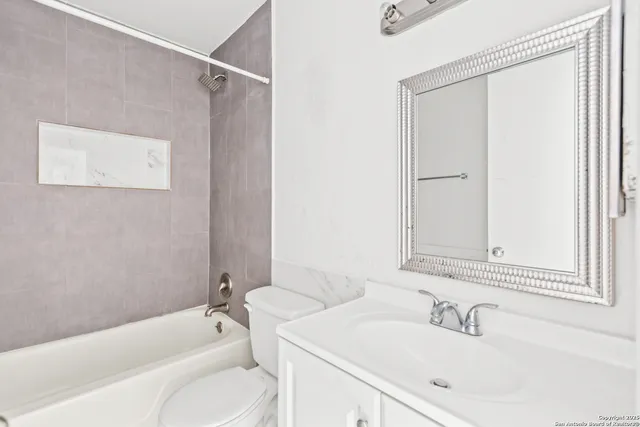 an empty room with chandelier fan