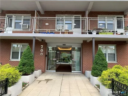 a view of a building with sitting space and plants