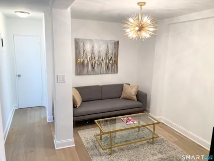 a living room with furniture and a chandelier