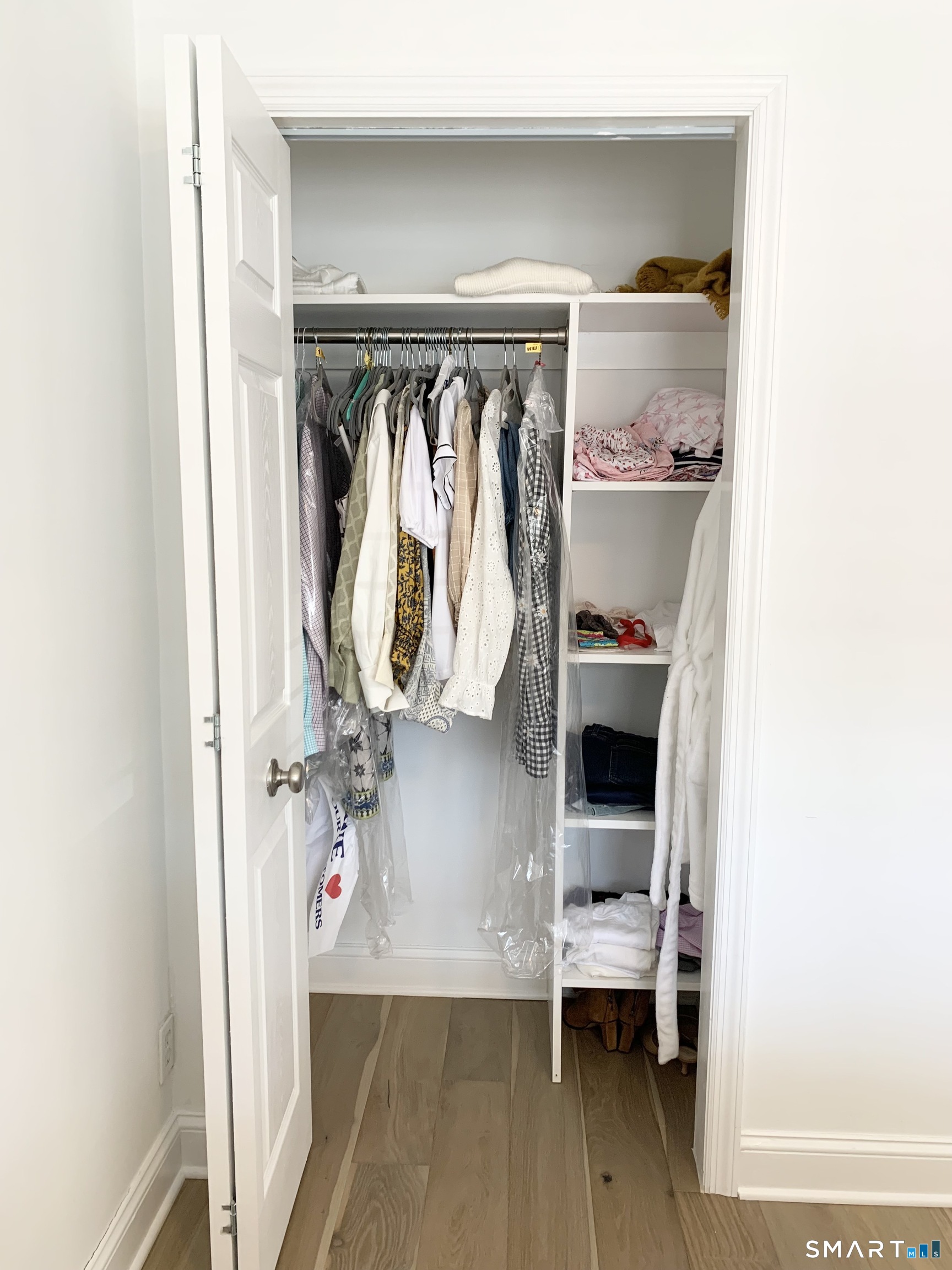 700 Summer Street, Unit 1M Stamford, CT 06901 - Photo 5 of 22 a view of walk in closet with clothes and shoes