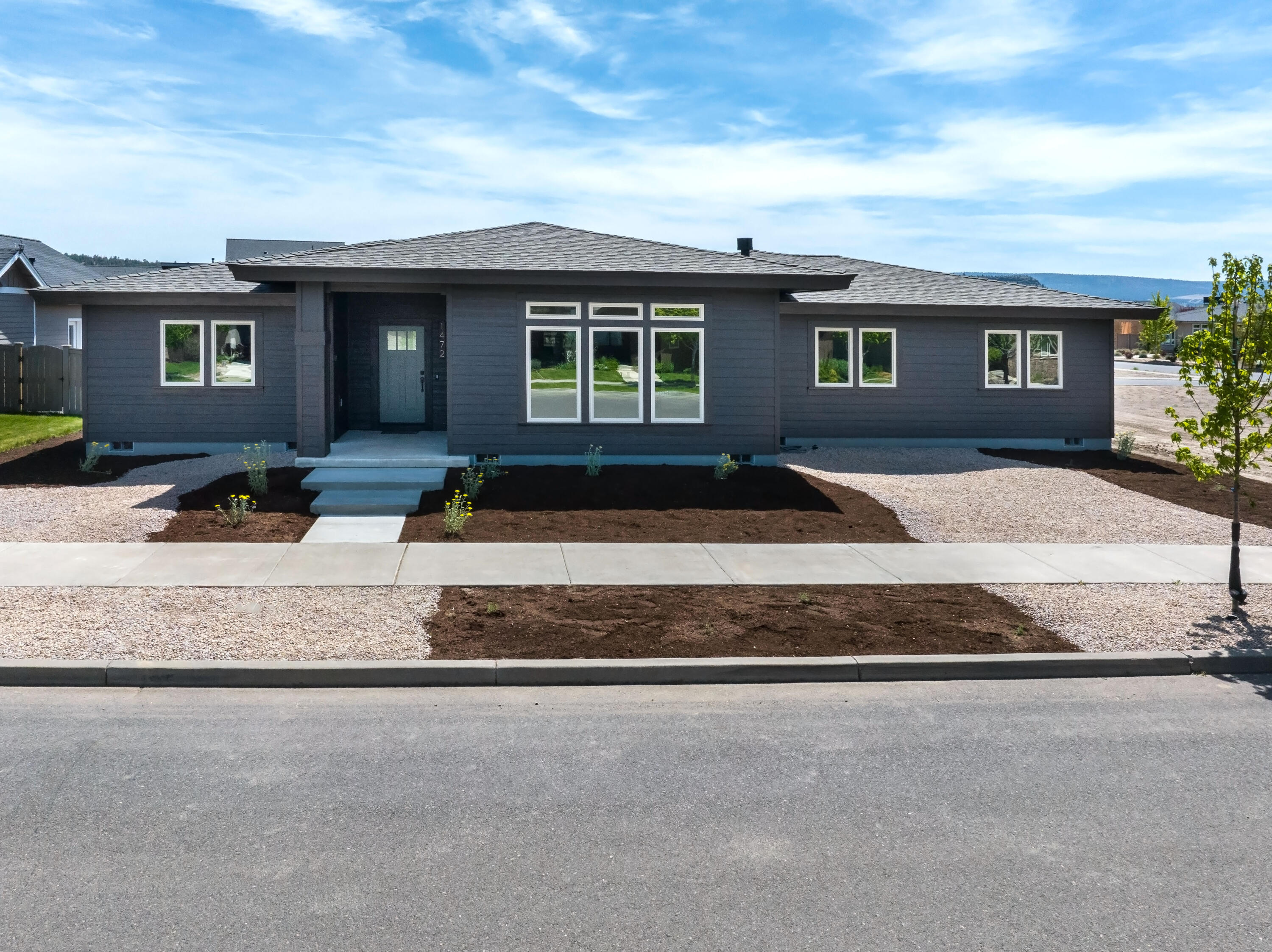 a front view of a house with a yard