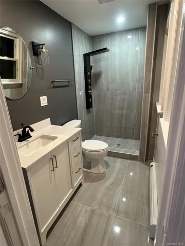 a bathroom with a sink a toilet and shower