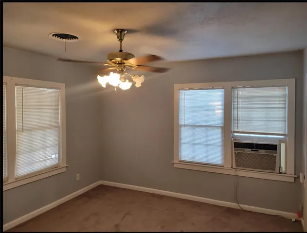 a room with chandelier and window